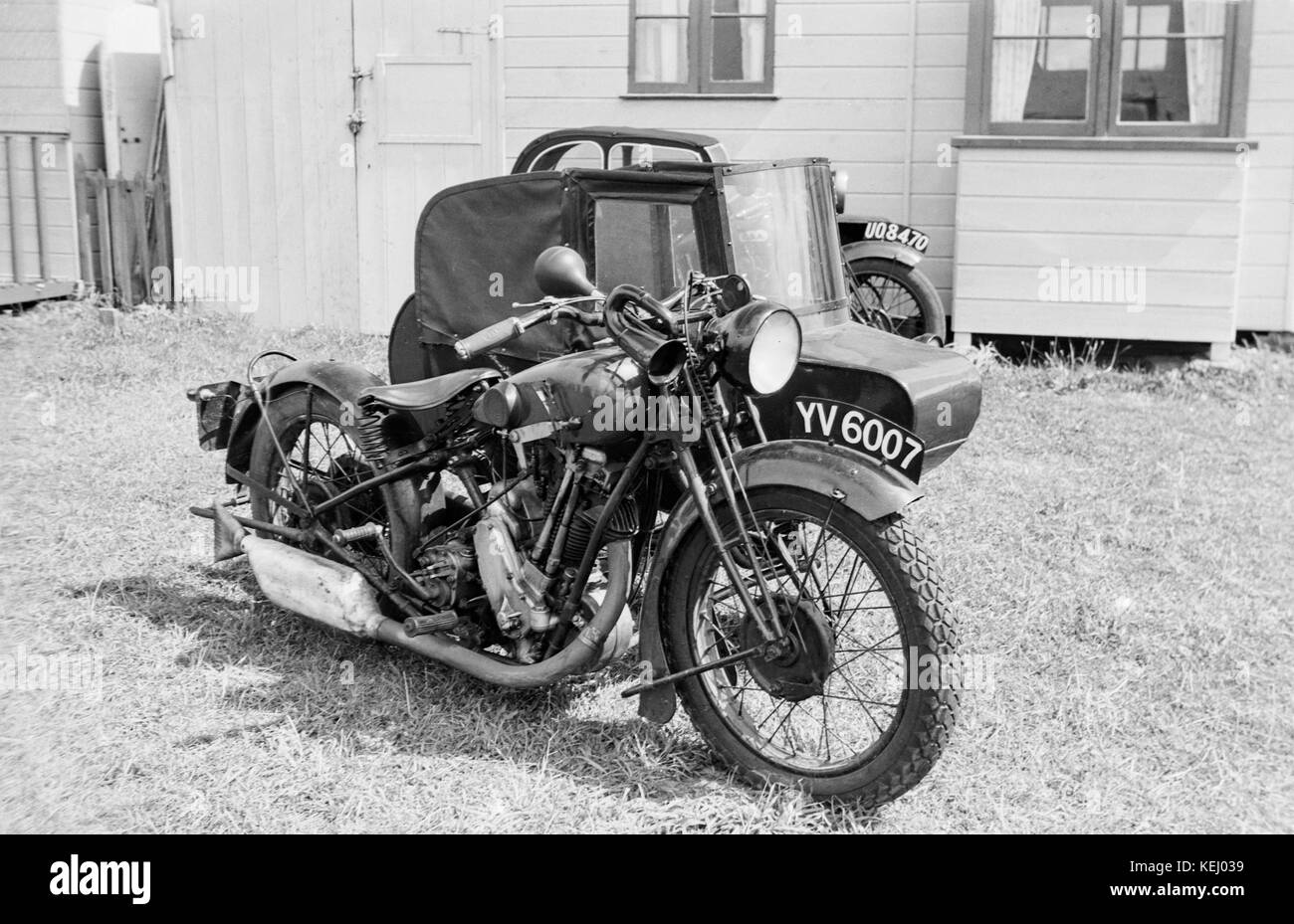 Vintage British BSA Sloper Motorcycle with sidecar.The BSA S-Series of motorcycles, most commonly known as the BSA Sloper, were a series of motorcycles produced by the Birmingham Small Arms Company (BSA) from 1927-1935.  Launched in 1927, the 493cc overhead valve engine was slanted, and the motorcycle featured a saddle tank that enabled a low seating position, improving the centre of gravity and handling. Designated as the new S-series, whether this stood for sloper, speed or silence is unknown, but sloper became the term used by motorcyclists and hence adopted by BSA for marketing. Stock Photo