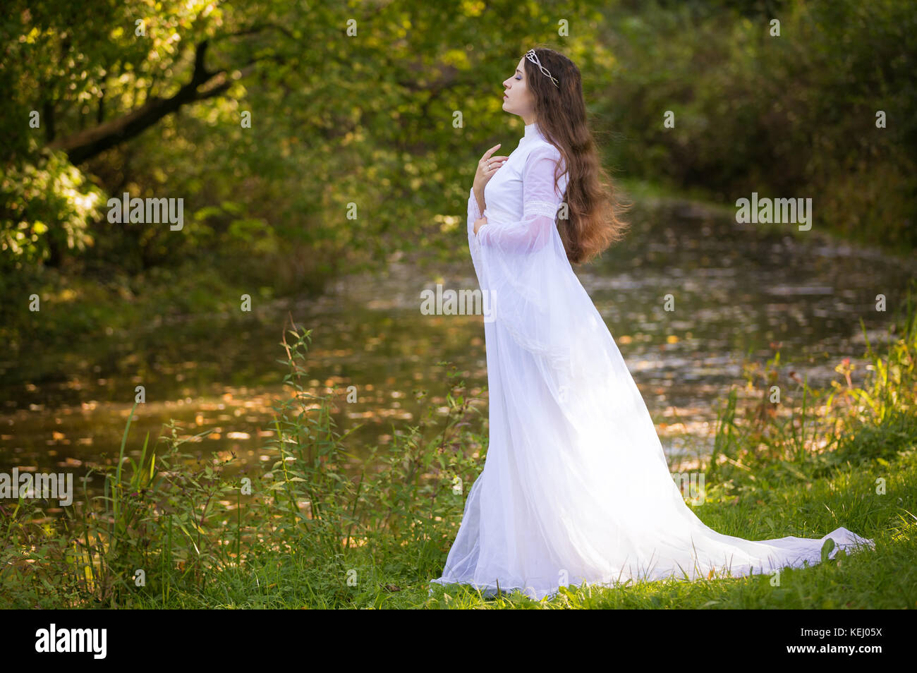 Princess with long hair in white long dress Stock Photo