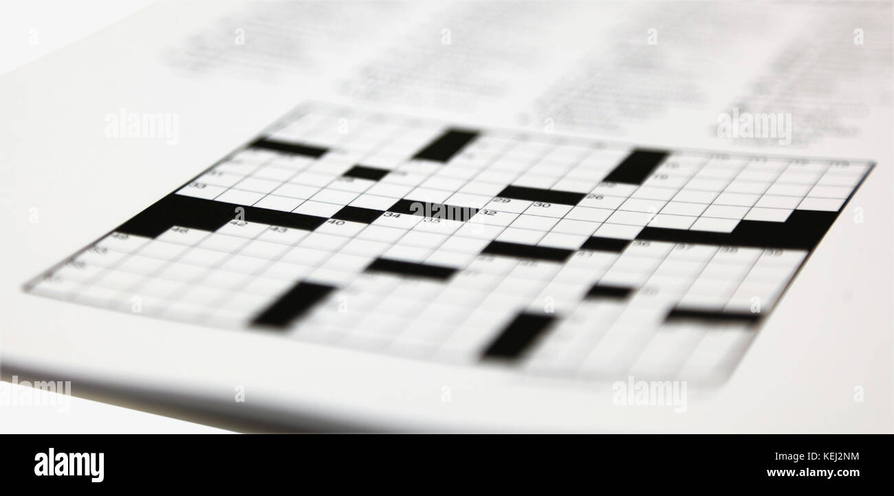 Shallow focus on daily newspaper crossword puzzle. Stock Photo