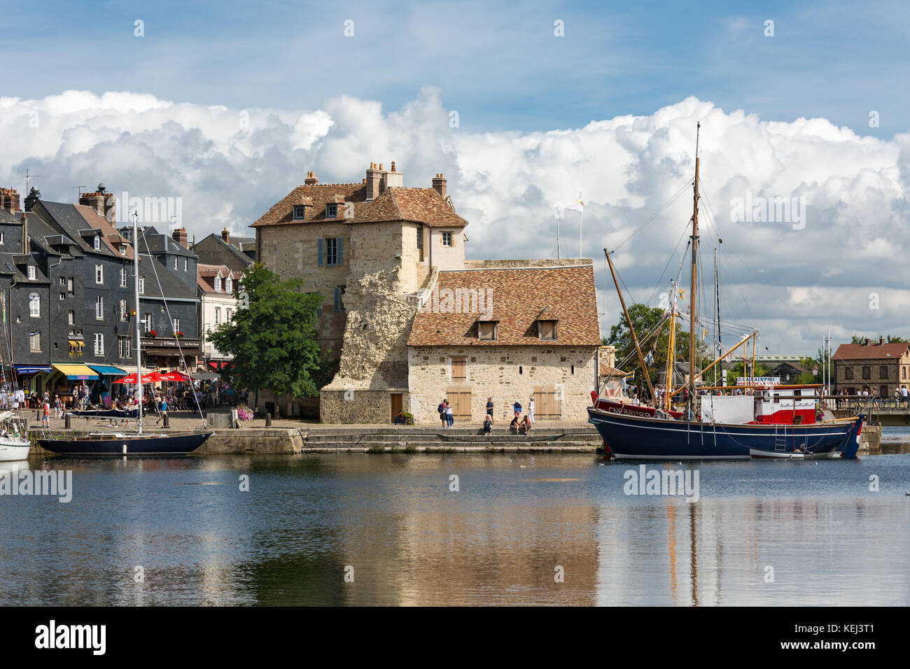 HONFLEUR, FRANCE - AUGUST 24, 2017: Harbor of historic city Honfleur with moord sailing ships. An impressive cloud bank is approaching the city Stock Photo