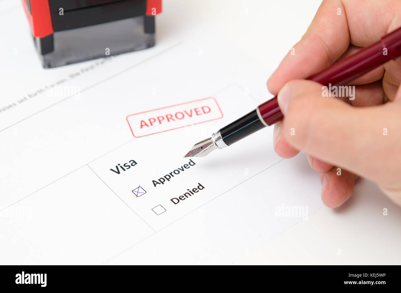 Visa and approved stamp on a document form. Immigration and travel concept Stock Photo