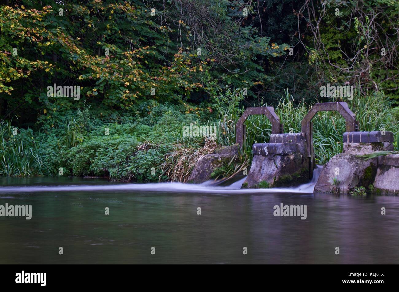 Long exposure of small waterfall on River Gade, Cassiobury Park, Watford Stock Photo