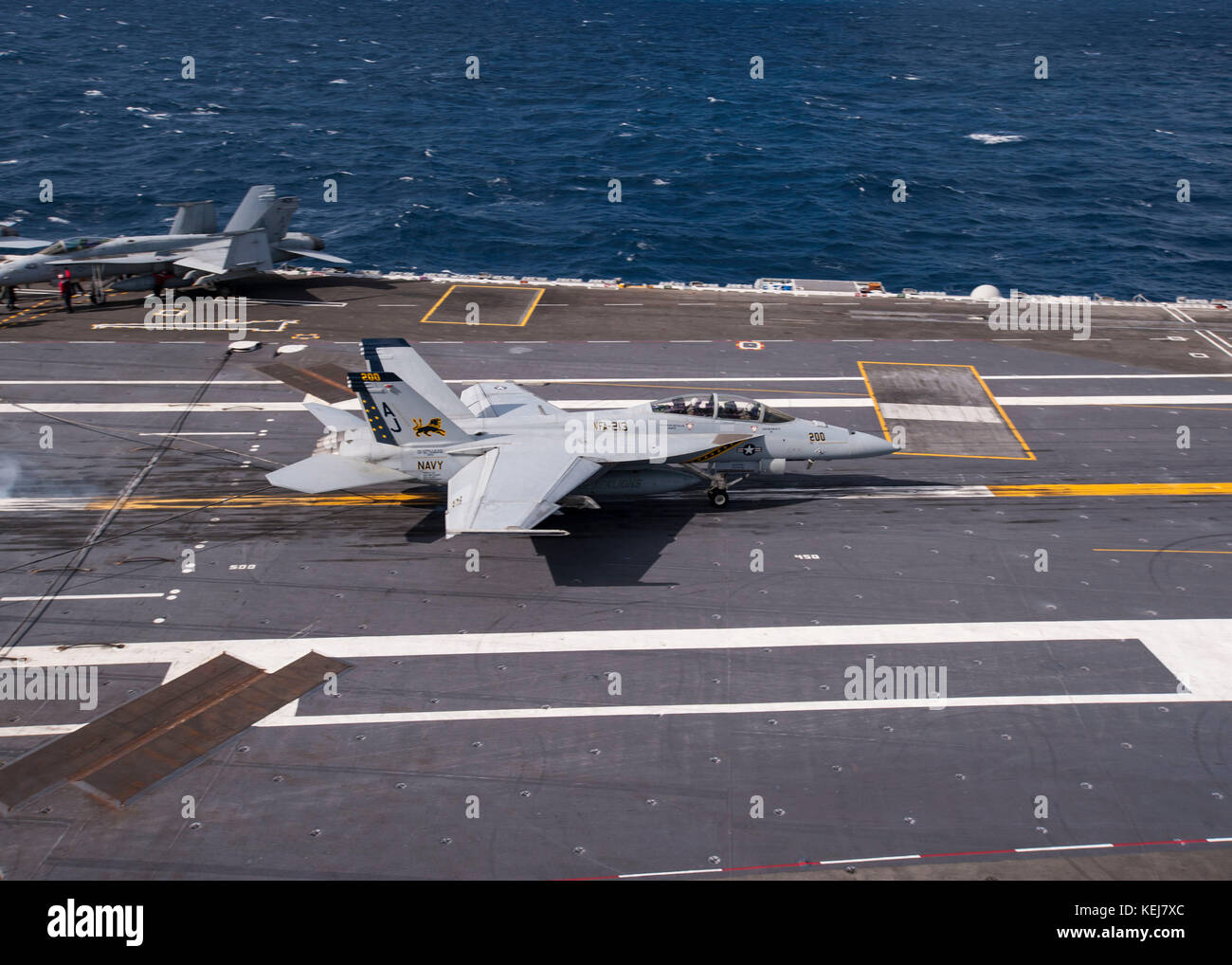 An F/A-18F Super Hornet attached to Strike Fighter Squadron (VFA) 213 traps on the flight deck of the aircraft carrier Stock Photo