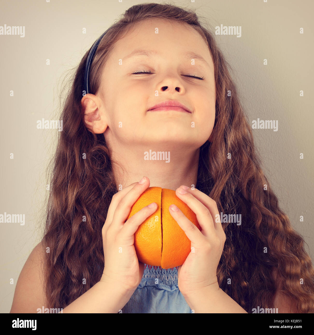 Cute Smiling Happy Kid Girl With Curly Hair Style Holding The