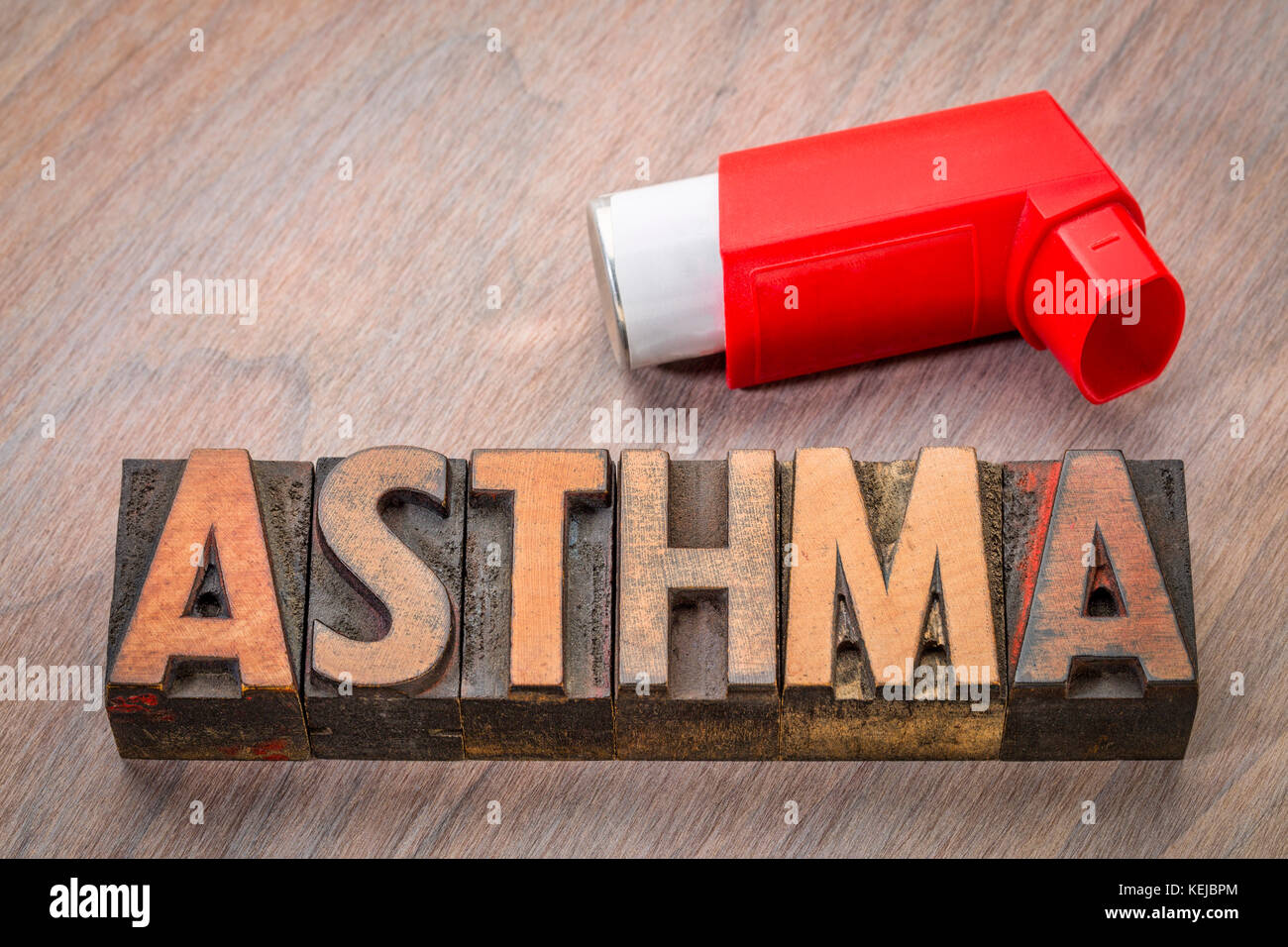 asthma word abstract in vintage letterpress wood type with an inhaler Stock Photo
