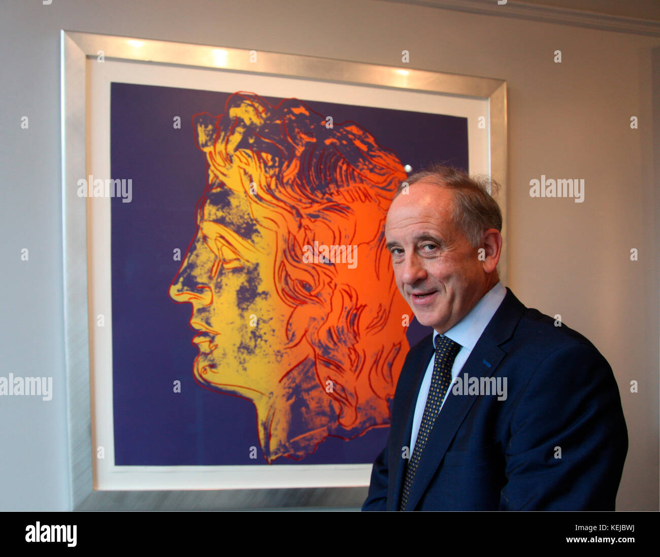 Art dealer Oliver Gormley of Gormley Fine Art with screenprint of Alexander the Great by Andy Warhol Stock Photo