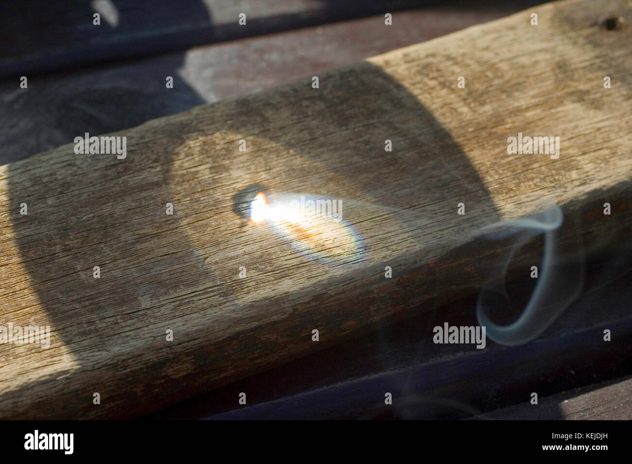 Magnifying glass used to burn wood Stock Photo Alamy