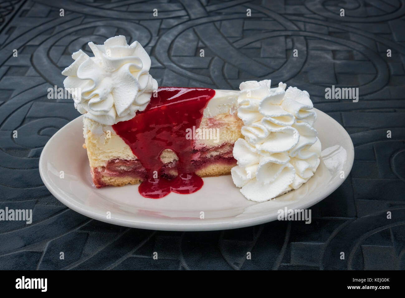 A slice of Raspberry and Cream Cheesecake from The Cheesecake Factory in Baltimore, Maryland, USA Stock Photo