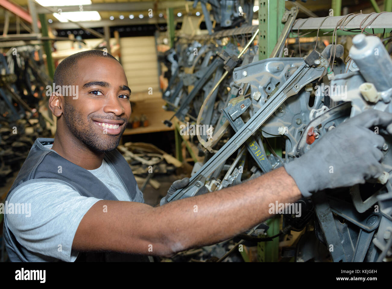 portrait of mechanic hanging up car parts in storage Stock Photo Alamy
