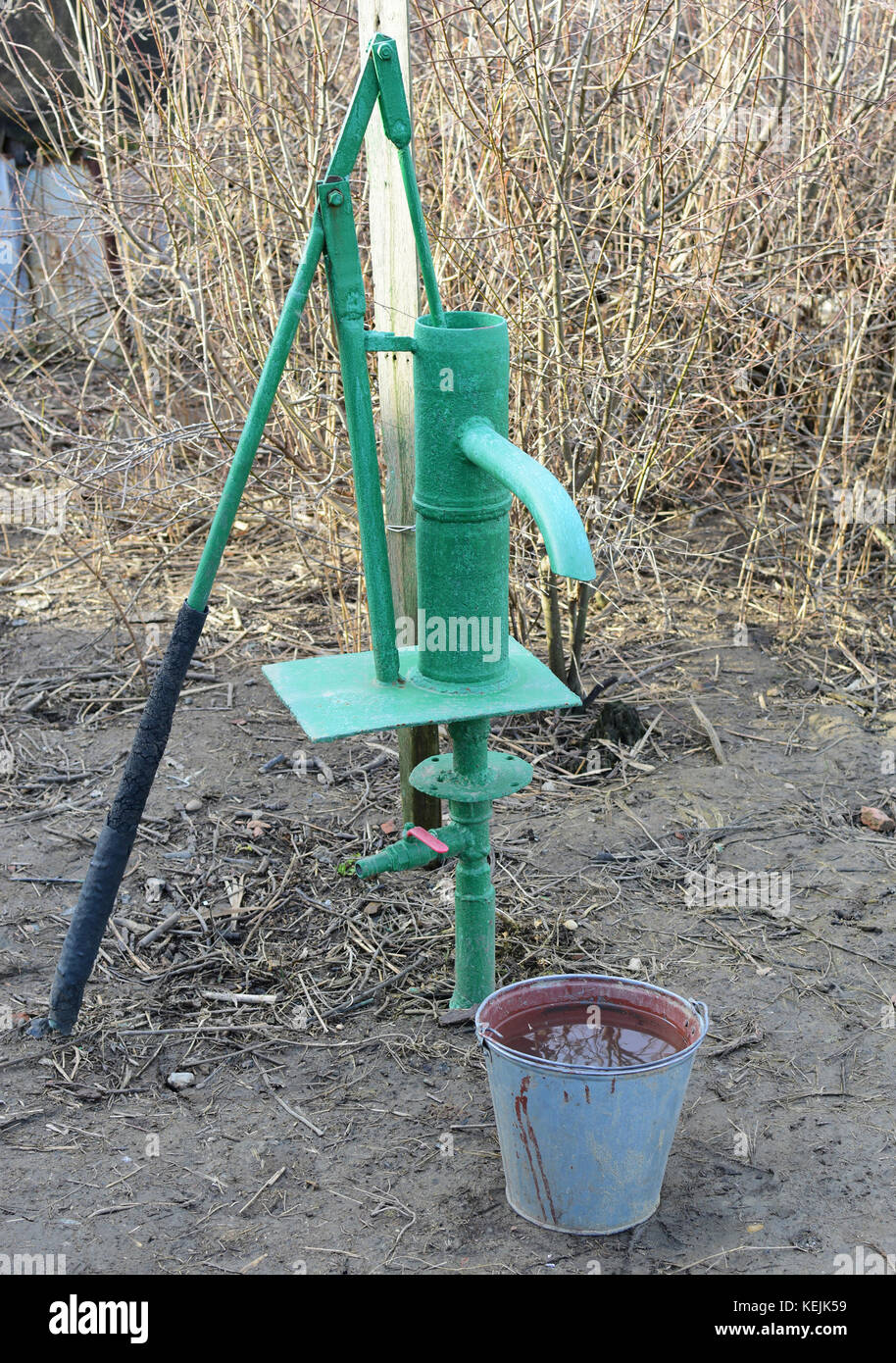 Hand pump leading to an artesian well. Pumping water for watering the
