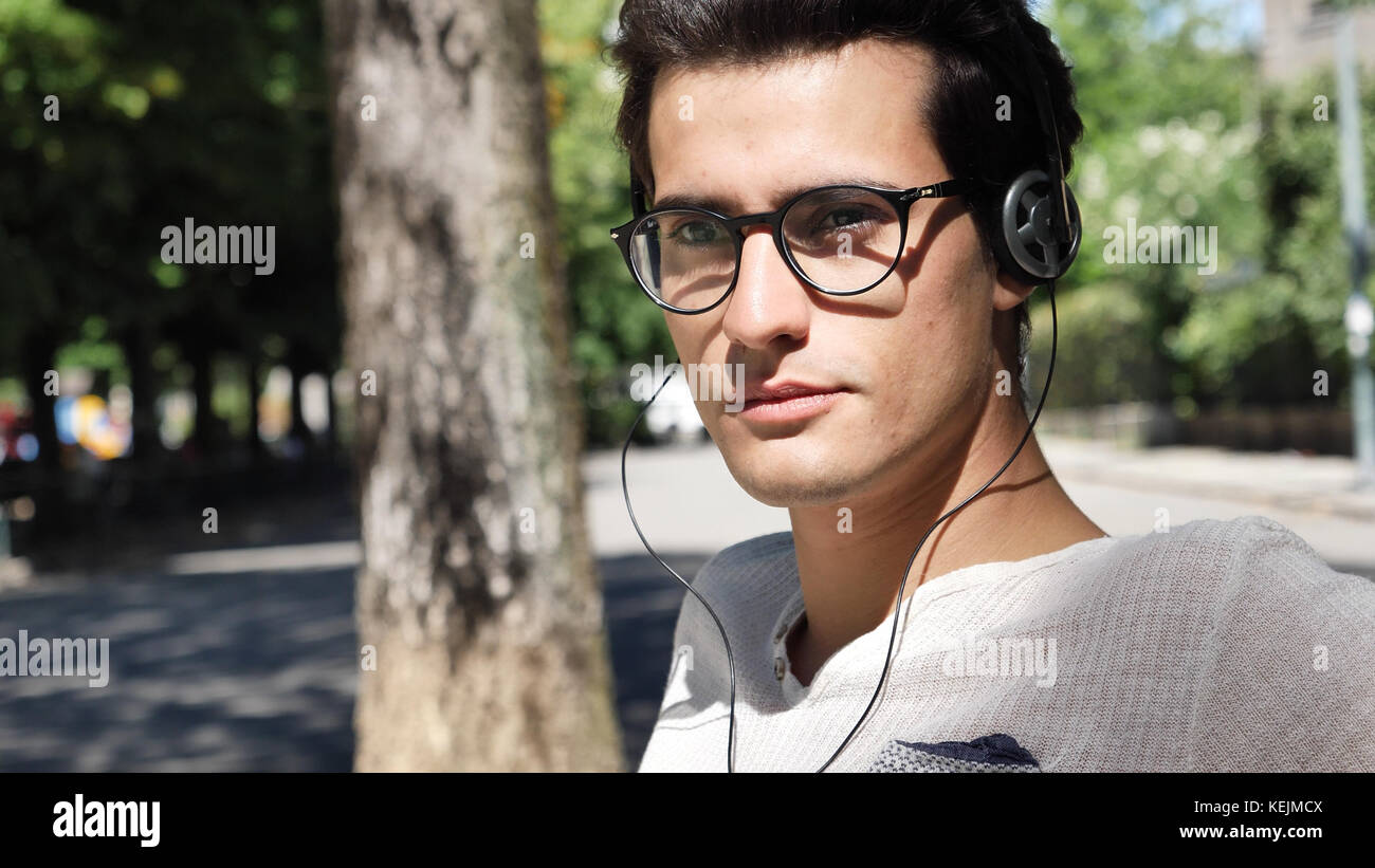 Close up Young Man Listening to his Favorite Music Using Headphone at