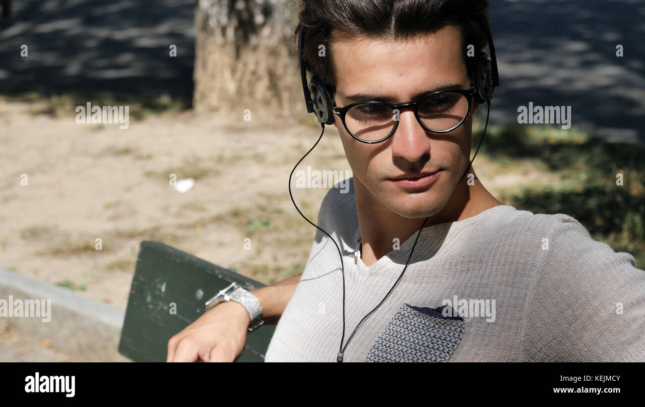 Close up Young Man Listening to his Favorite Music Using Headphone at