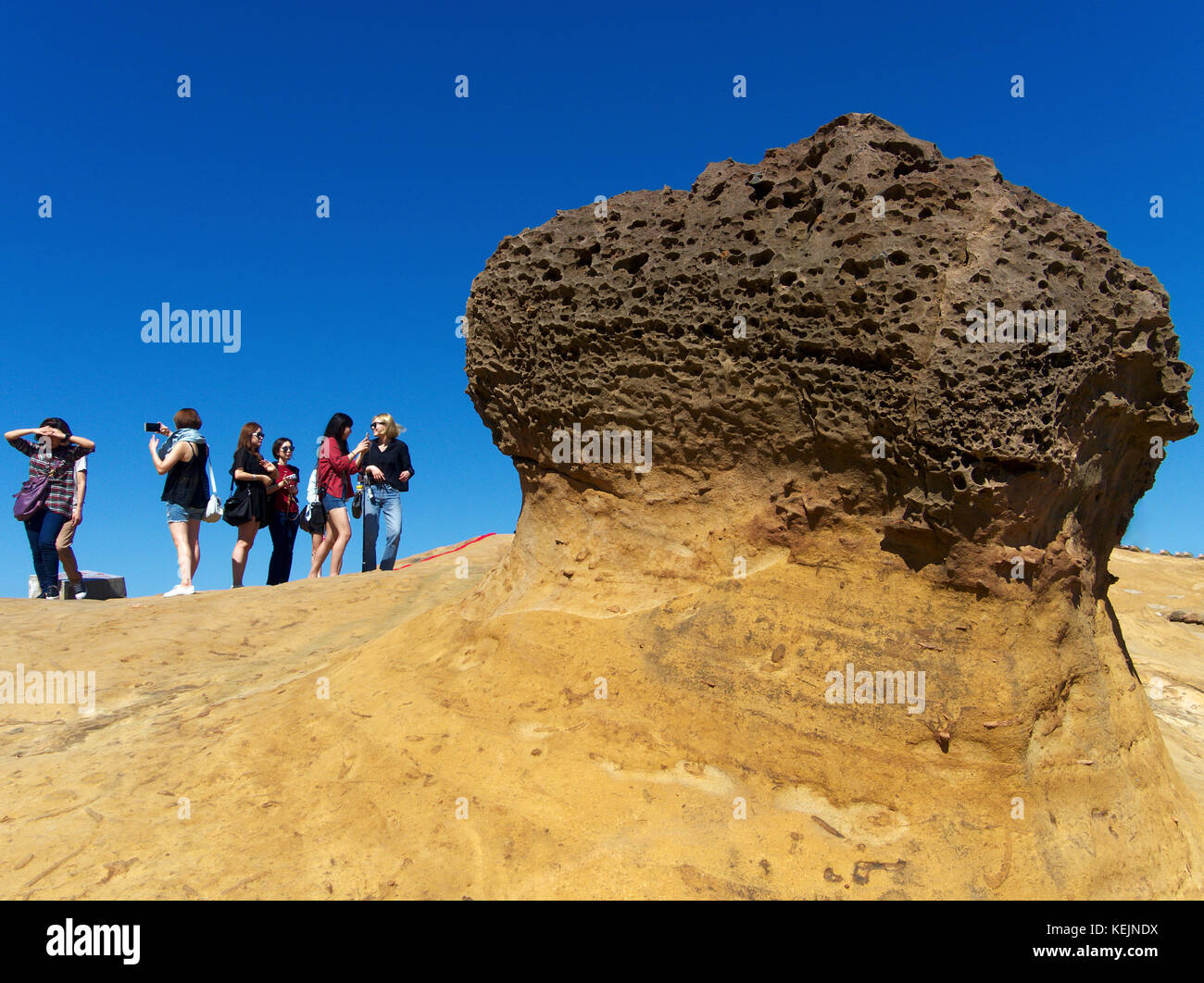 Visitors taking photos of a unique rock formation at Yehliu Geopark, Wanli, Taiwan Stock Photo
