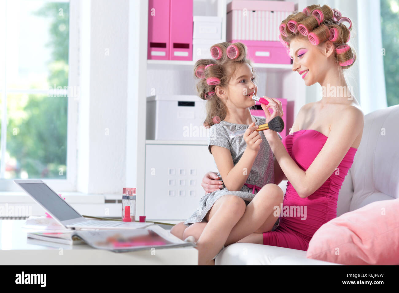 mother with cute daughter doing makeup  Stock Photo