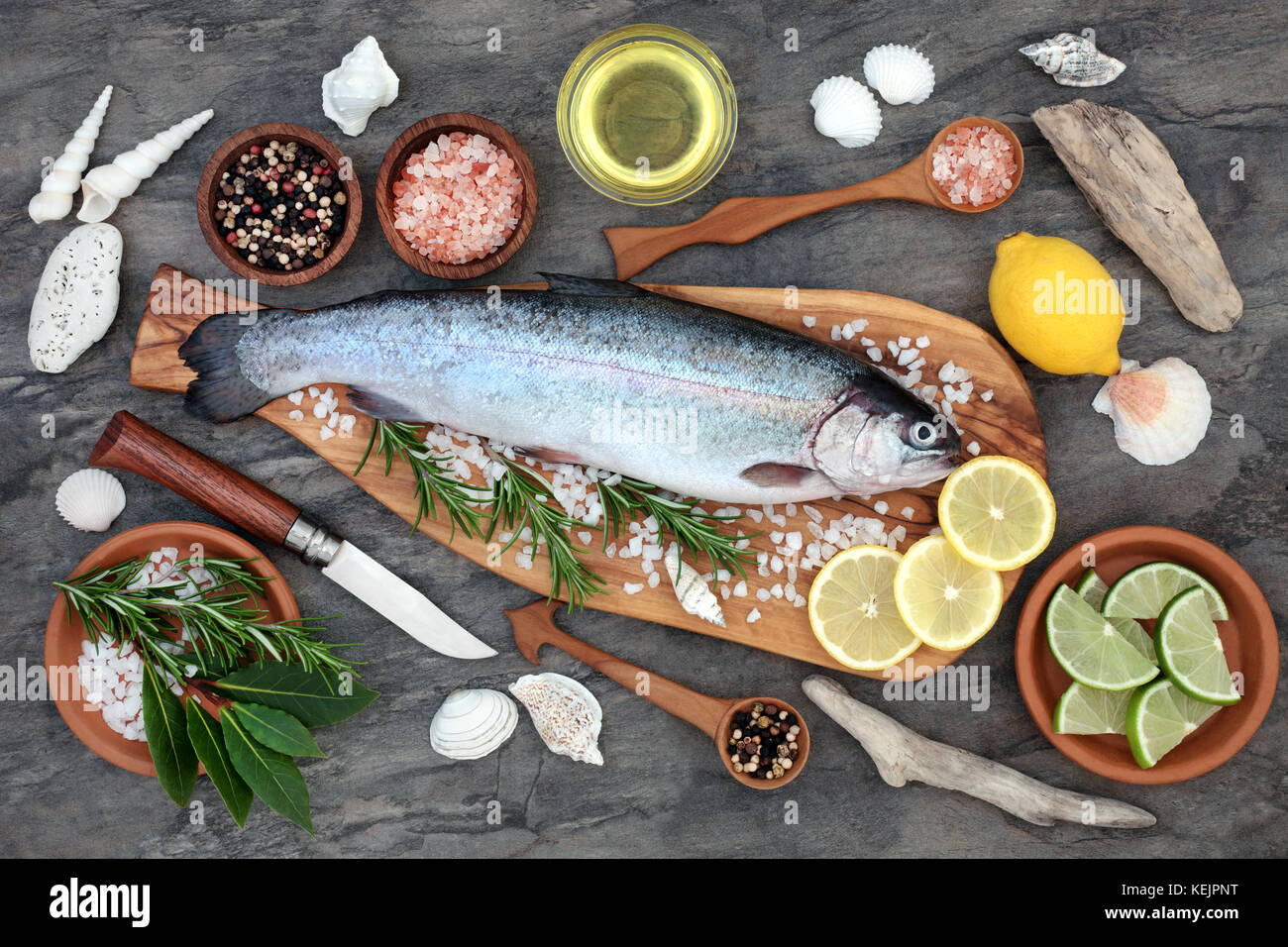 Rainbow trout health food on an olive wood board with seasoning. Very