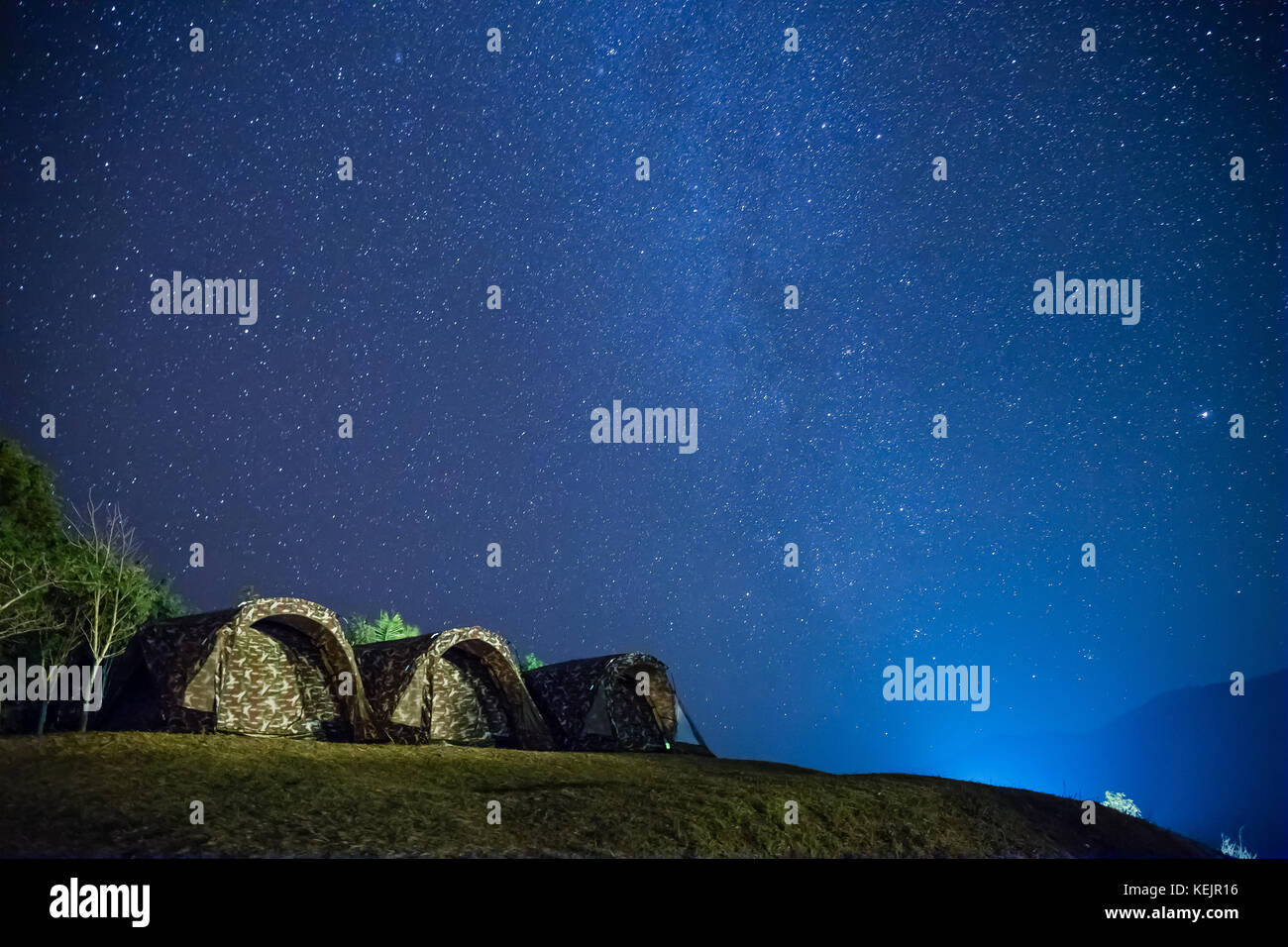 Camping with stars in the night sky - Doy Samur Dow, Nan, Thailand Stock Photo