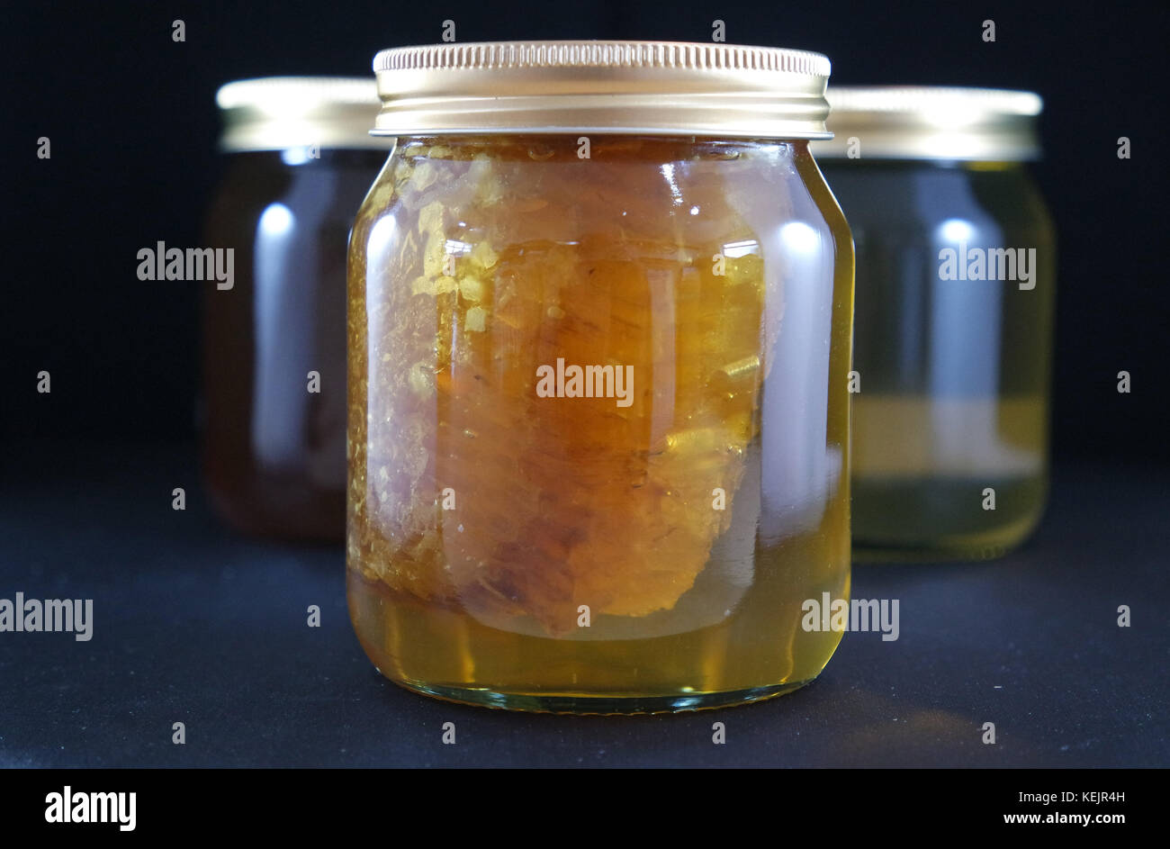 Jar of Honey with bees wax comb Stock Photo