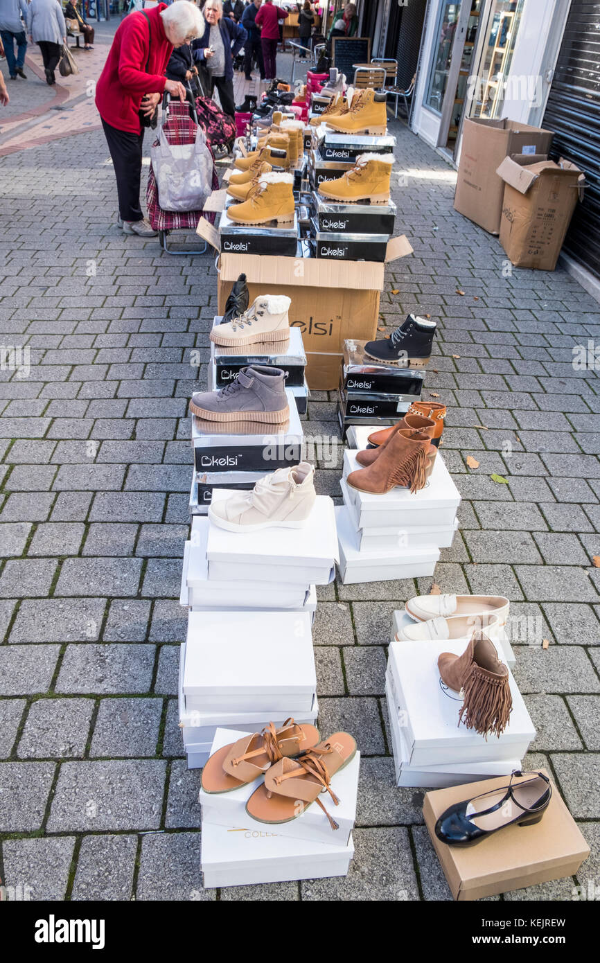 Selling on the street. Shoes on sale along a pavement, Nottinghamshire, England, UK Stock Photo
