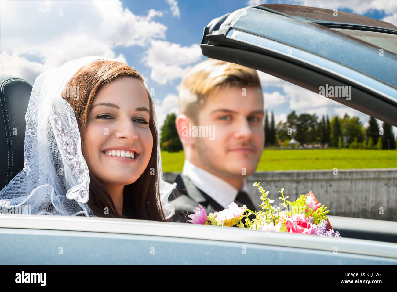 Portrait Of Young Just Married Couple In The Car Stock Photo