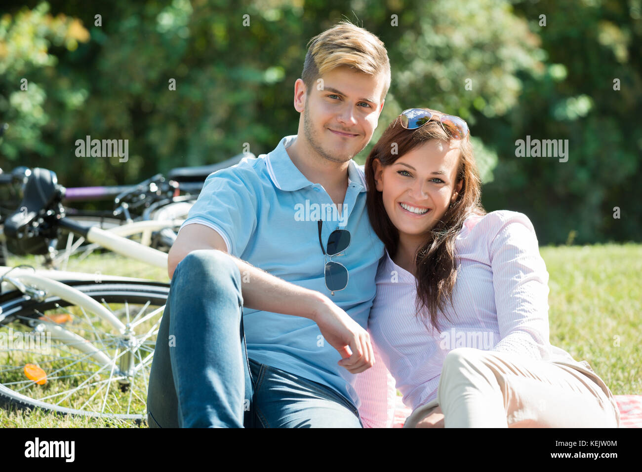 Portrait Of Smiling Young Couple In Park Stock Photo - Alamy