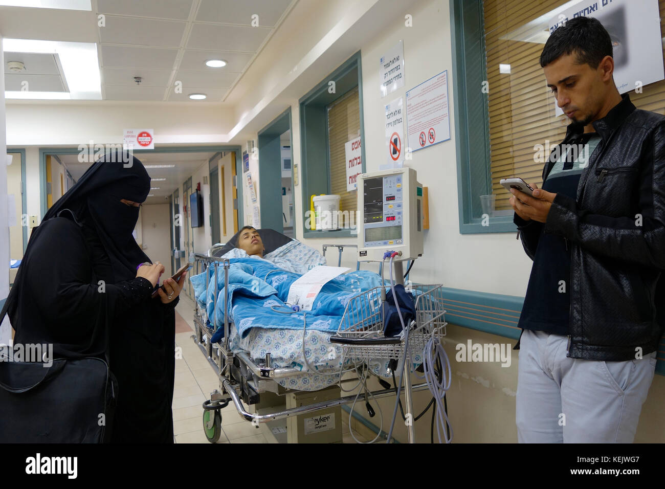 A Palestinian woman wearing niqab using her cellular phone in Hadassah Medical Center at Ein Kerem West Jerusalem Israel Stock Photo