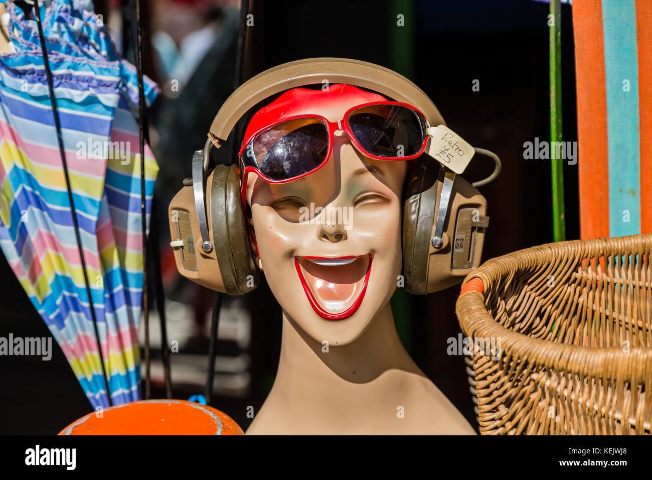 Retro laughing mannequin head with headphones and sun glasses Stock Photo