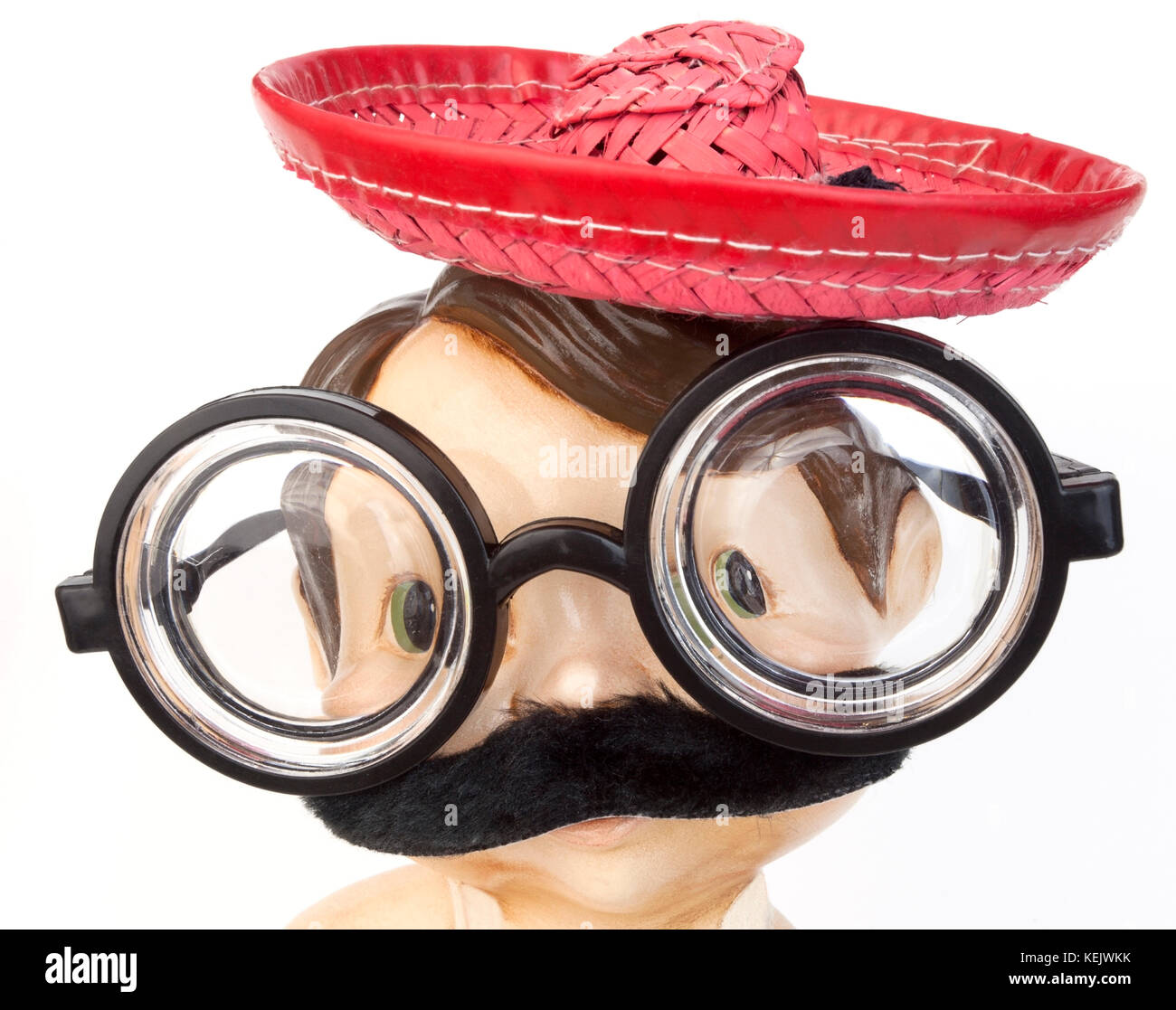 Silly goofy face made with red straw hat, mustache and nerd glasses. Isolated. Stock Photo