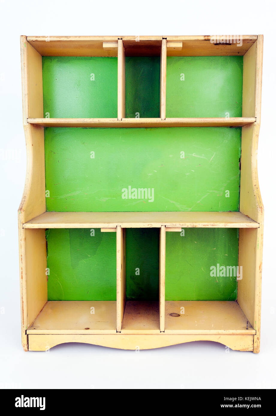 Vintage yellow and green child's toy cupboard. Isolated. Vertical. Stock Photo