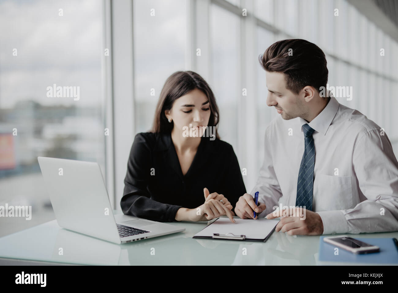 Business meeting. Two professionals signing contract in office Stock ...