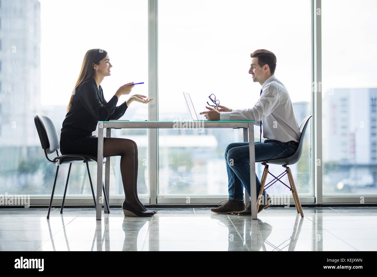 Businessman And Businesswoman Meeting In Modern Office Stock Photo - Alamy