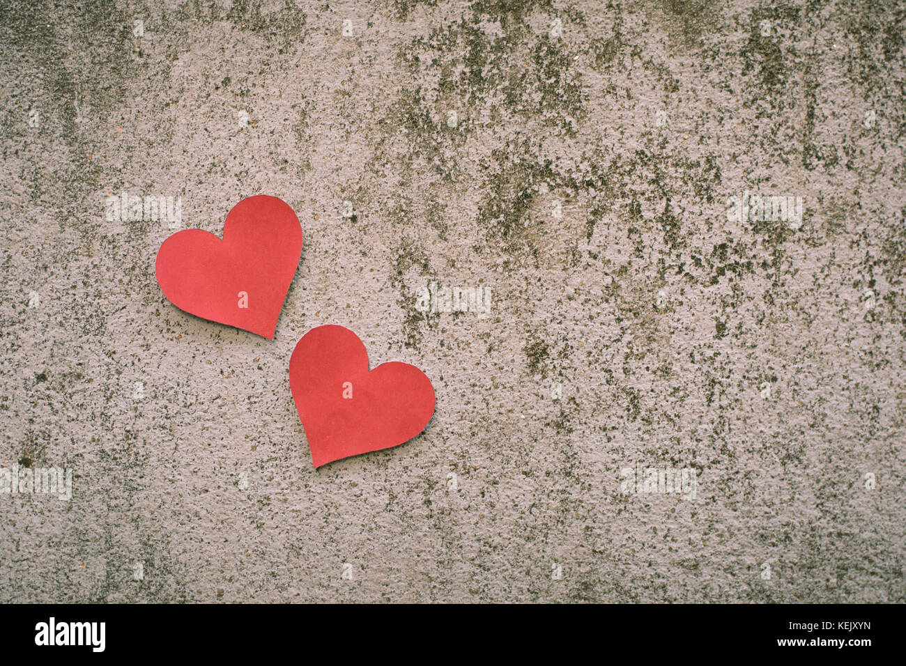 red paper heart shape on concrete background Stock Photo - Alamy