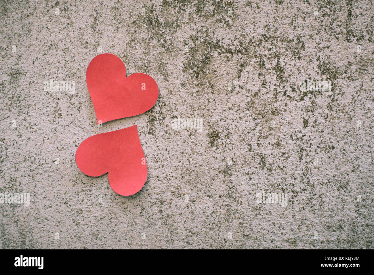 red paper heart shape on concrete background Stock Photo - Alamy