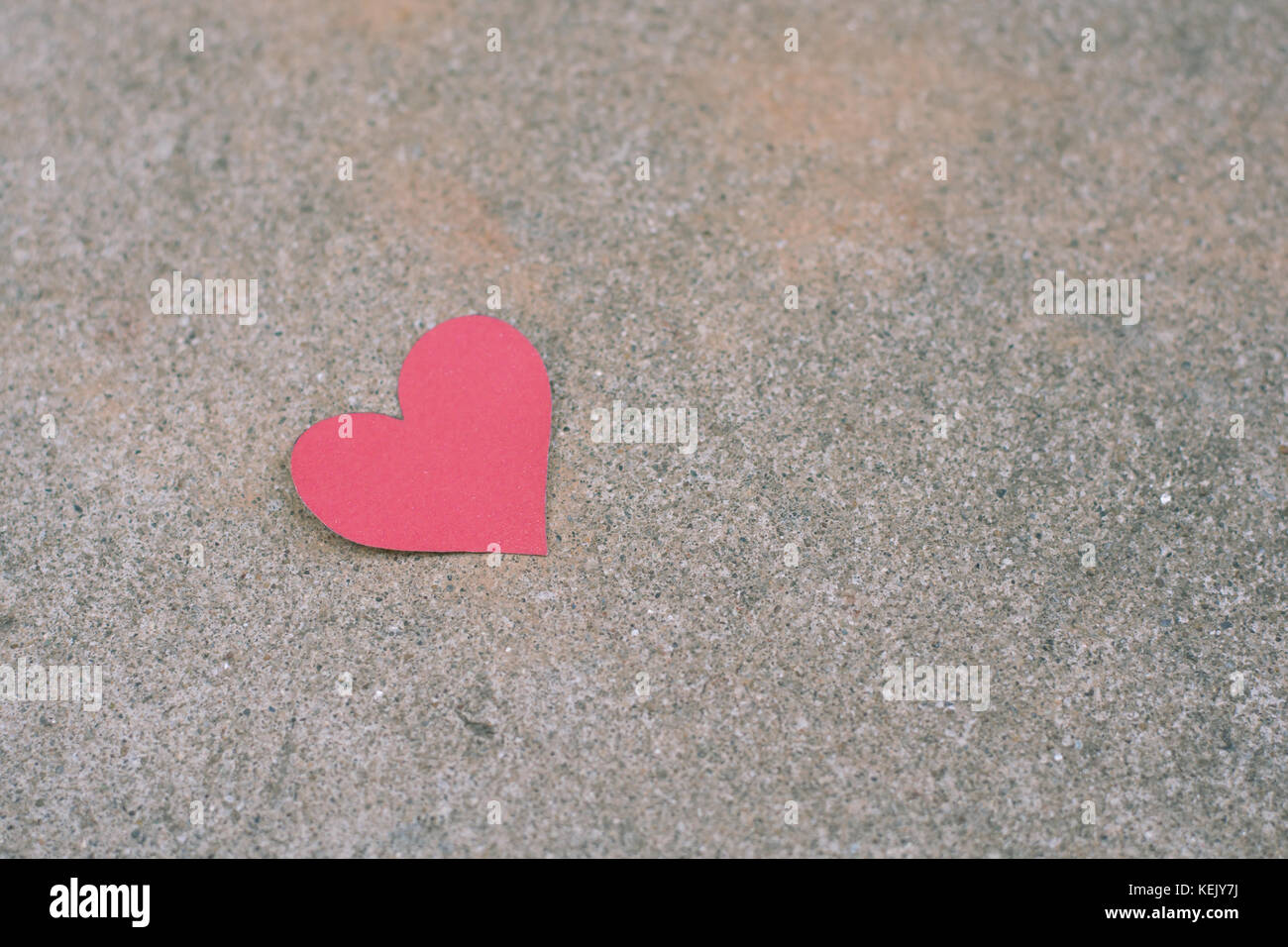 red paper heart shape on concrete background Stock Photo - Alamy