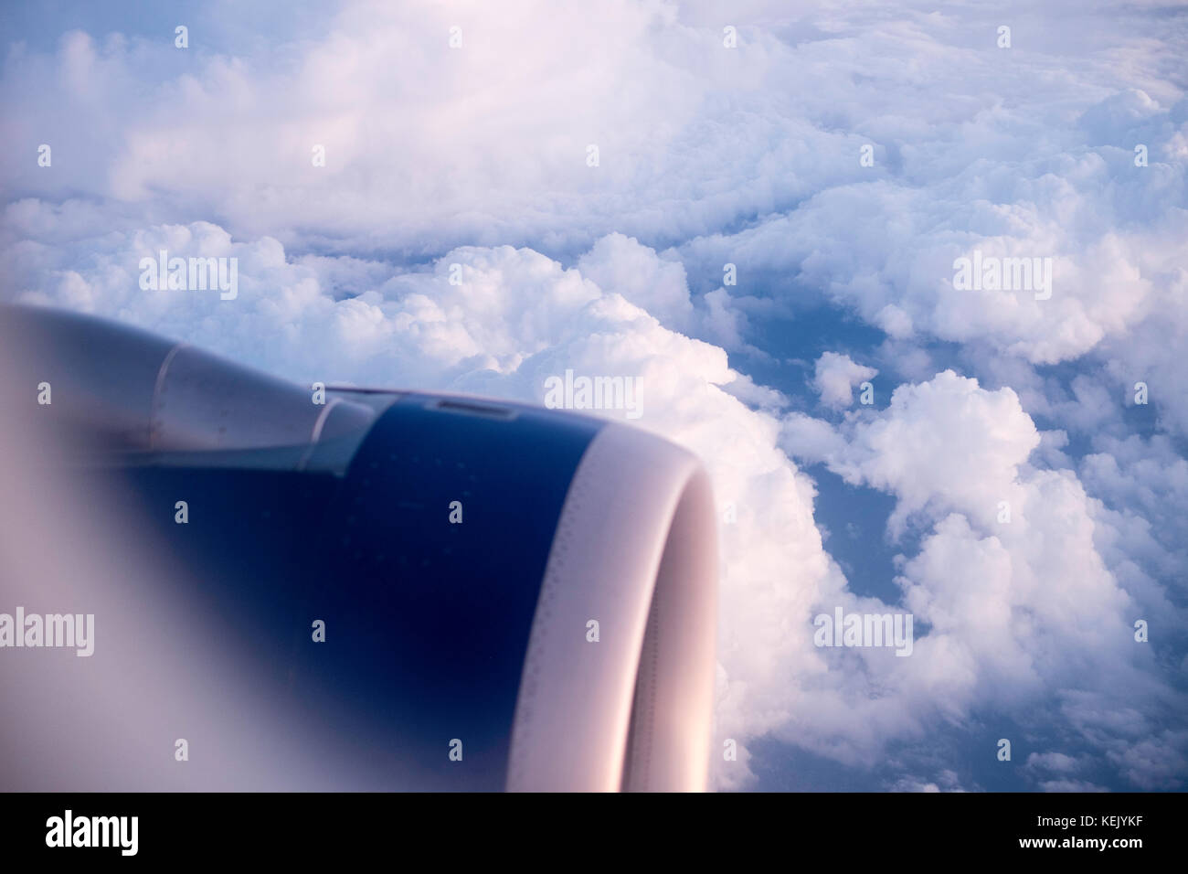 View from an airplane window on the clouds below Stock Photo
