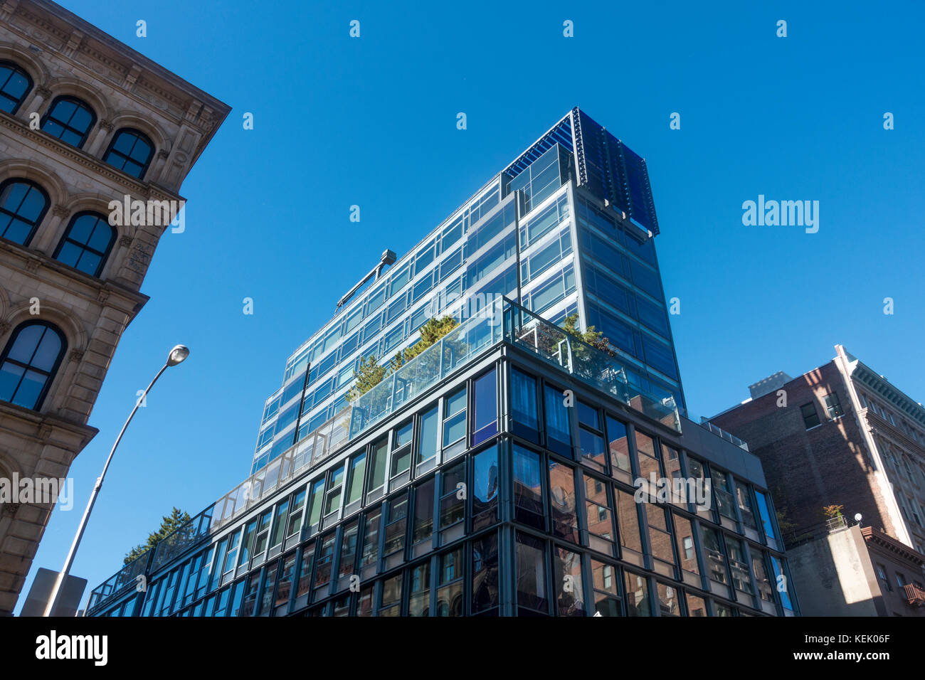 Modern glass building in the Historic Cast Iron District of SoHo in Lower Manhattan Stock Photo
