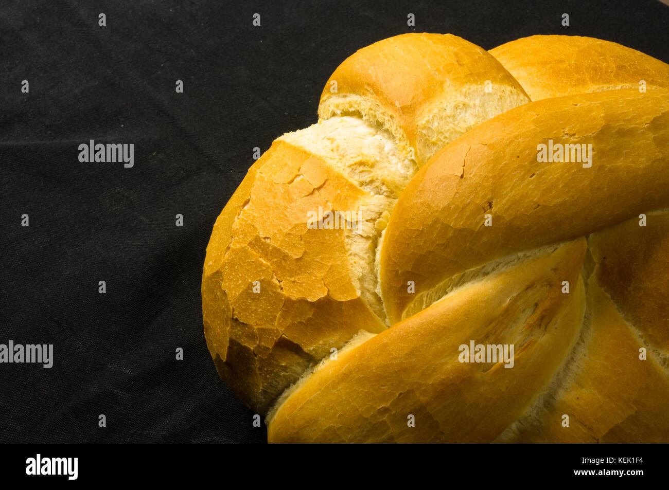 fresh braided loaf of white wheat bread on black background Stock Photo ...