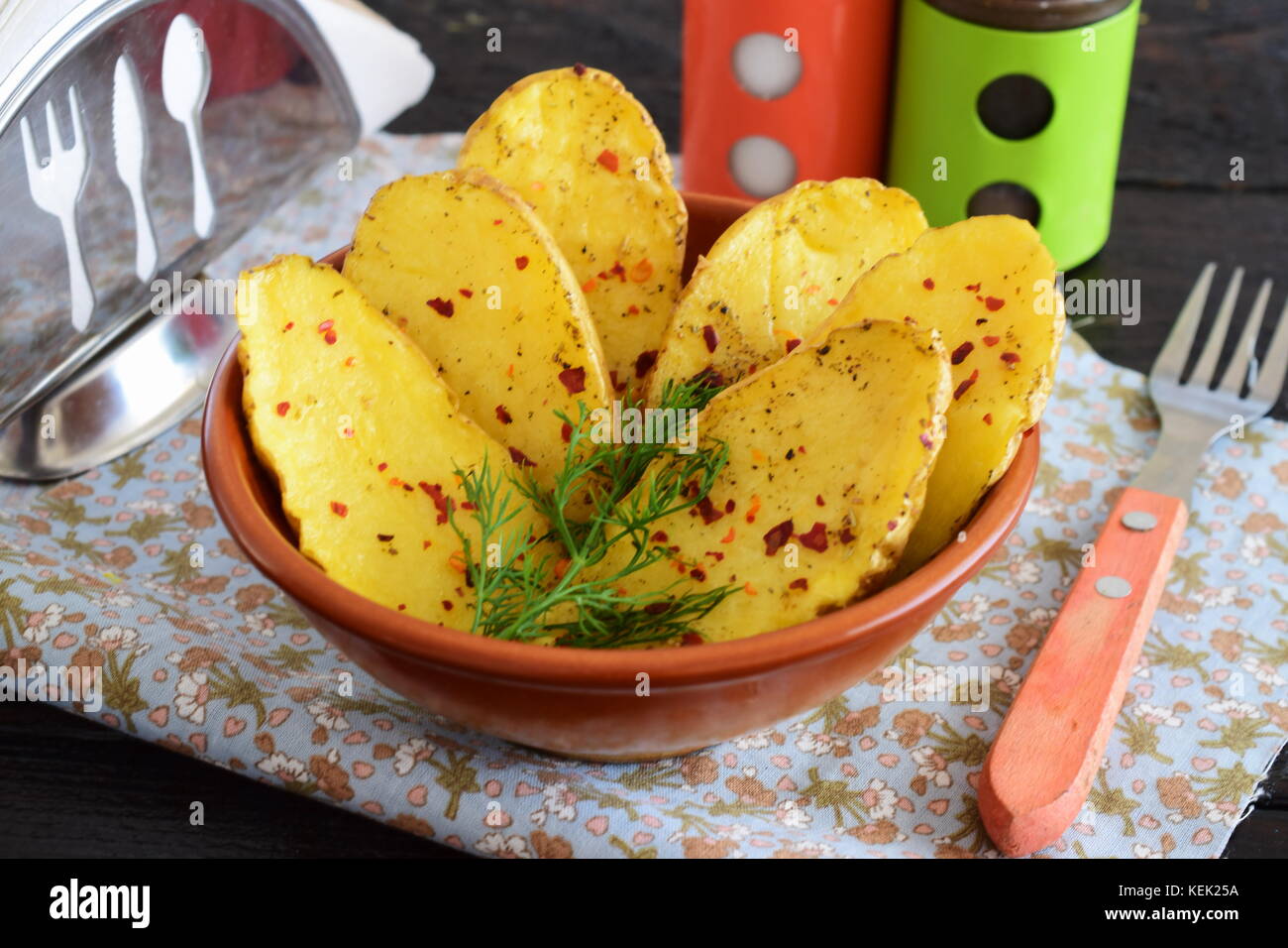 Oven baked halves of potato with spices and olive oil. Healthy eating