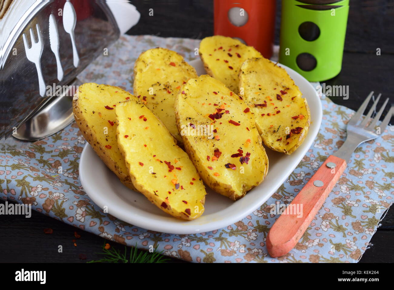 Oven baked halves of potato with spices and olive oil. Healthy eating