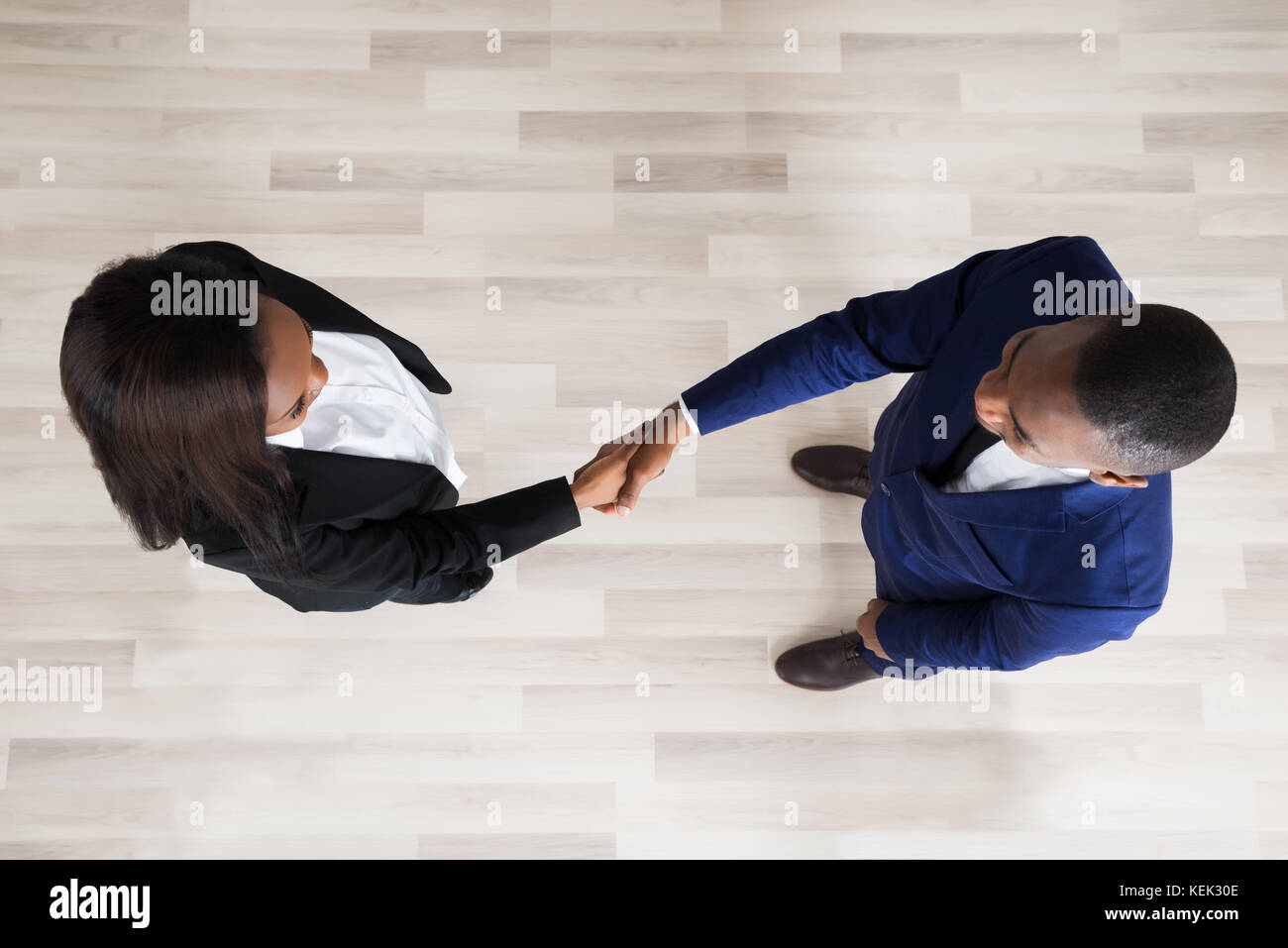 Elevated View Of Business Man And Woman Handshaking Stock Photo