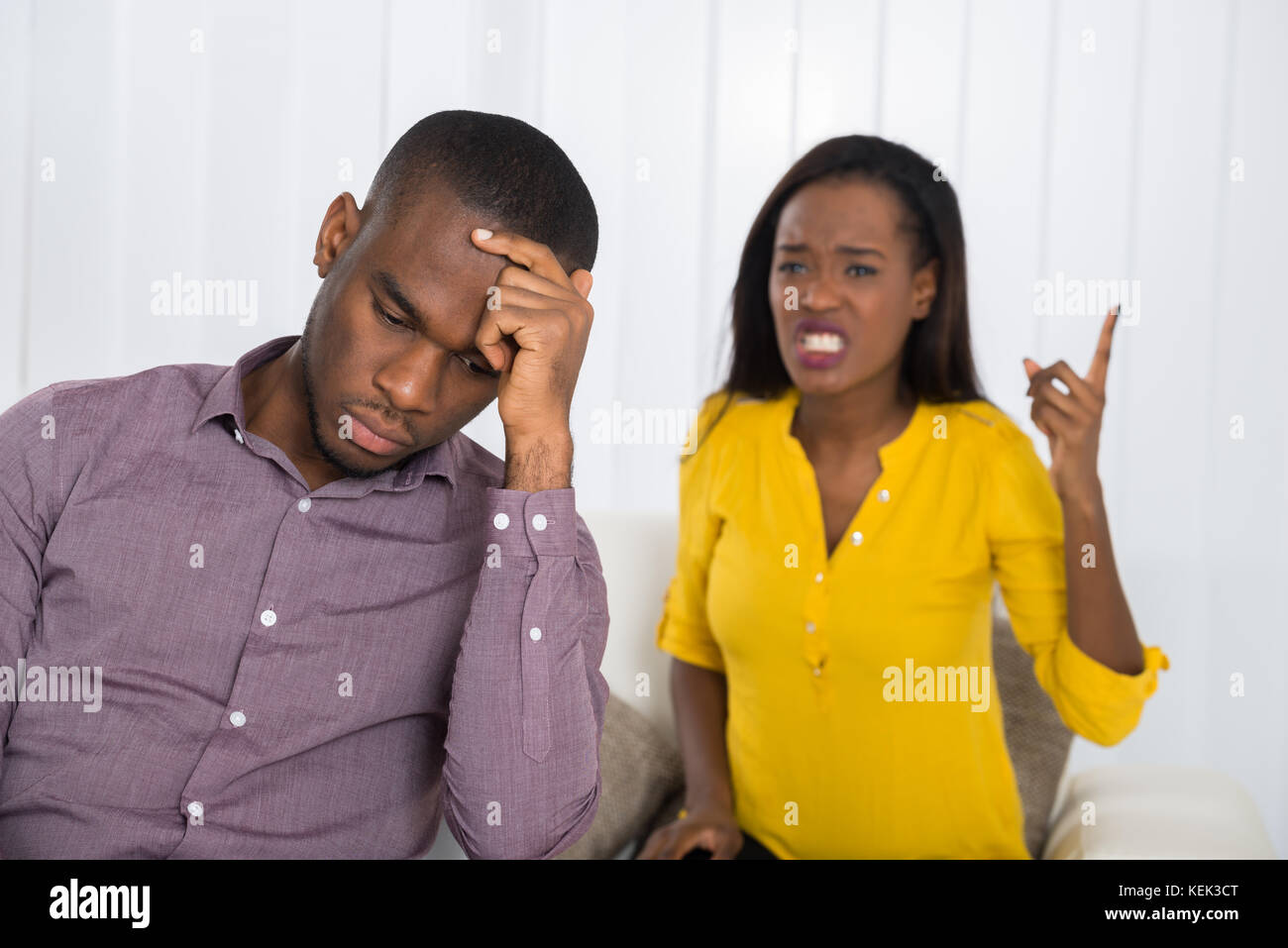 Unhappy Young Woman Having Argument With Man At Home Stock Photo
