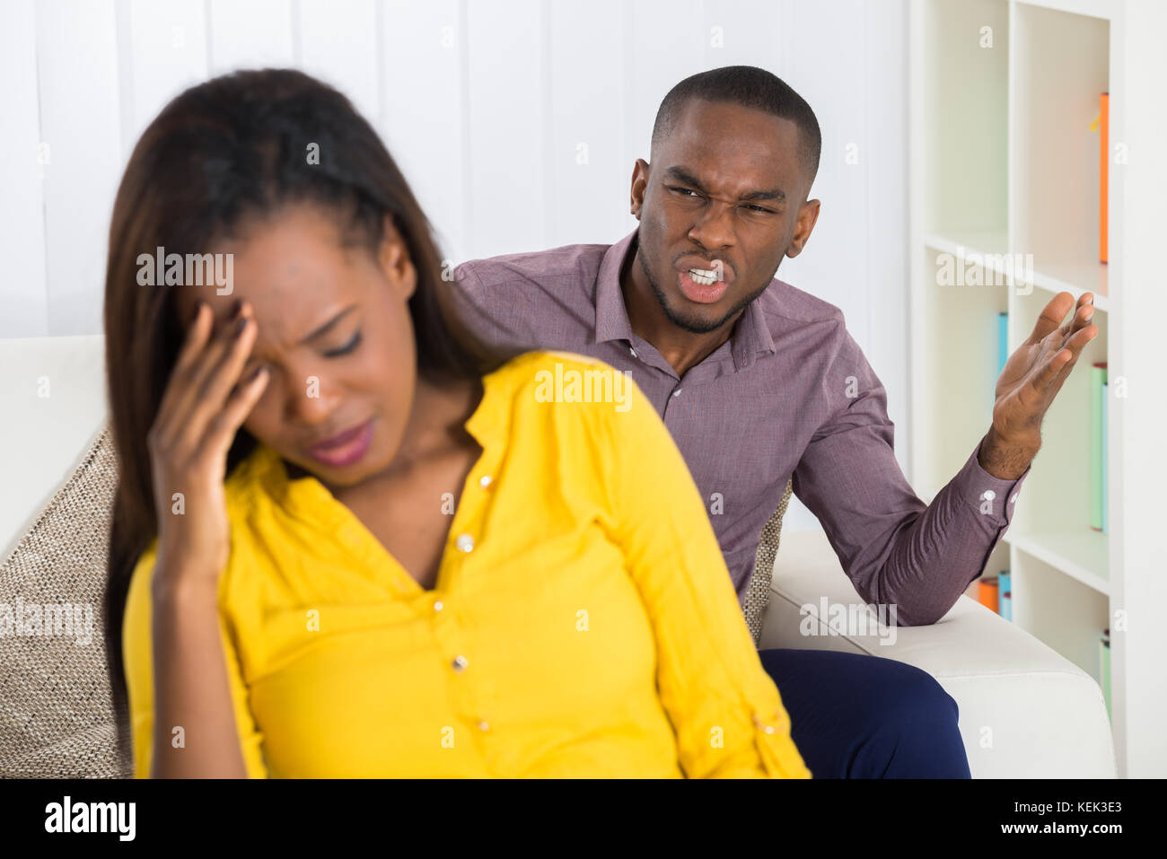 Unhappy Young Man Having Argument With Woman At Home Stock Photo