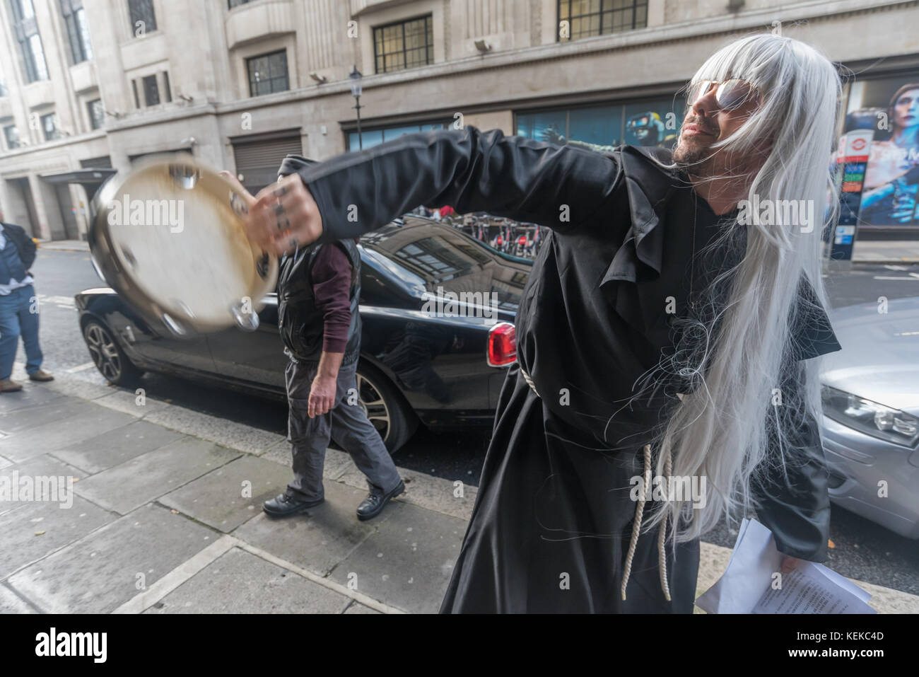London, UK. October 21st 2017. Celebrating the 50th anniversary of the Yippee levitation of the Pentagon during anti-Vietnam War protests, Class War's Ian Bone, shaman Jimmy Kunt (aka Adam Clifford) and supporters went to Northcliffe House to levitate the Daily Mail. Security staff there reacted angrily to Class War calling out the demon of Paul Dacre and their attempt to raise the building by over 70 metres, perhaps fearing it might damage the Rolls-Royce parked outside, but the levitation ceremony went ahead despite considerable interference. Peter Marshall/Alamy Live News Stock Photo