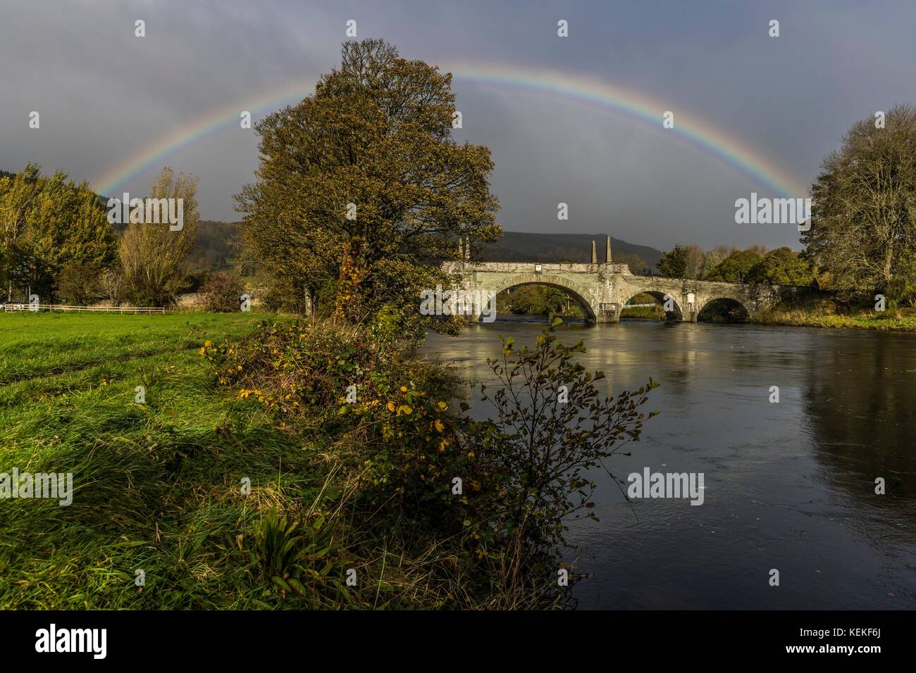Aberfeldy, Scotland, UK. 22nd October, 2017. A rainbow arches over the top of the Tay Bridge in Aberfeldy. Opened in 1735 by General Wade and designed by William Adam, the bridge still carries road traffic from the Highlands int Aberfeldy. Credit: Rich Dyson/Alamy Live News Stock Photo