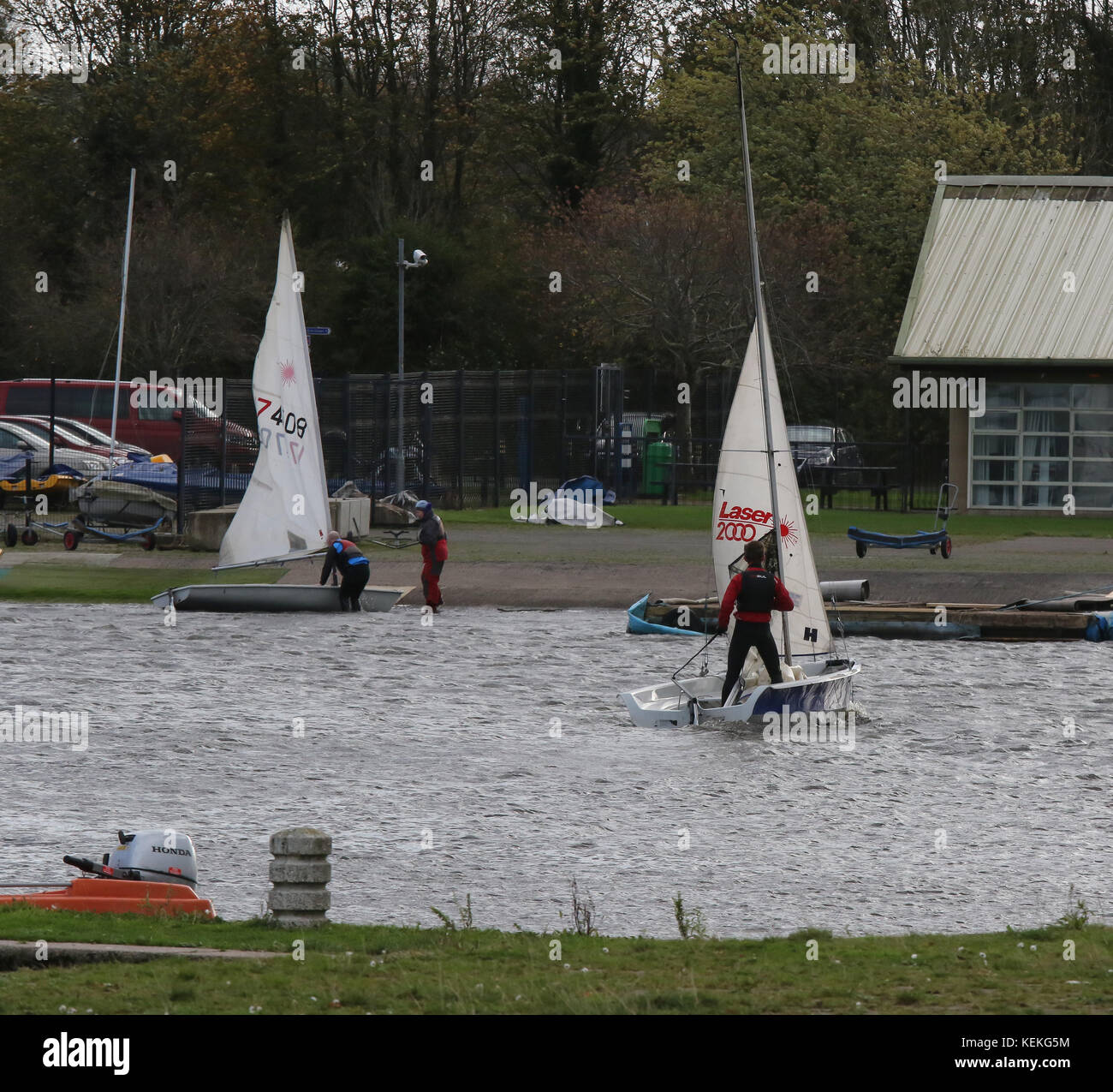 Craigavon Lakes, Northern Ireland UK. 22 October 2017. After another windy night unsettled weather continued in Northern Ireland today. Strong north-westerly winds up to lunchtime meant theses dinghy-sailors didn't venture out beyond the water-sports' harbour at the south lake. Credit: David Hunter/Alamy Live News. Stock Photo