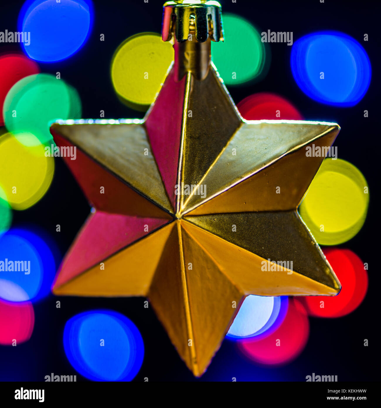 A macro shot of a golden star shaped Christmas bauble. Stock Photo