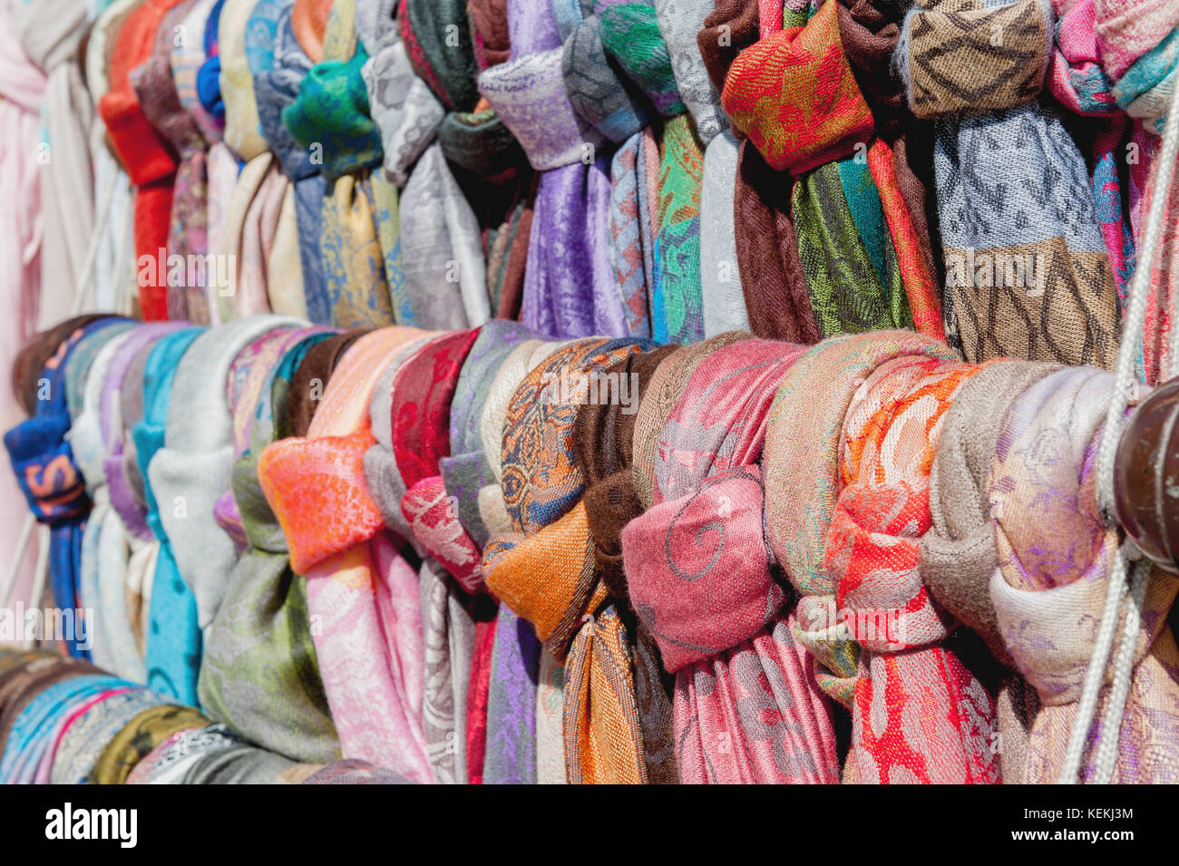 Showcase street of minimarket women's colorful scarves . The horizontal frame. Stock Photo