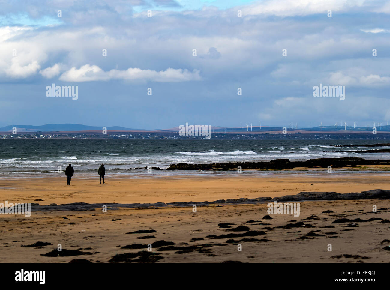 Photograph of a Couple walking on Fanore Beach in the West of Ireland Stock Photo