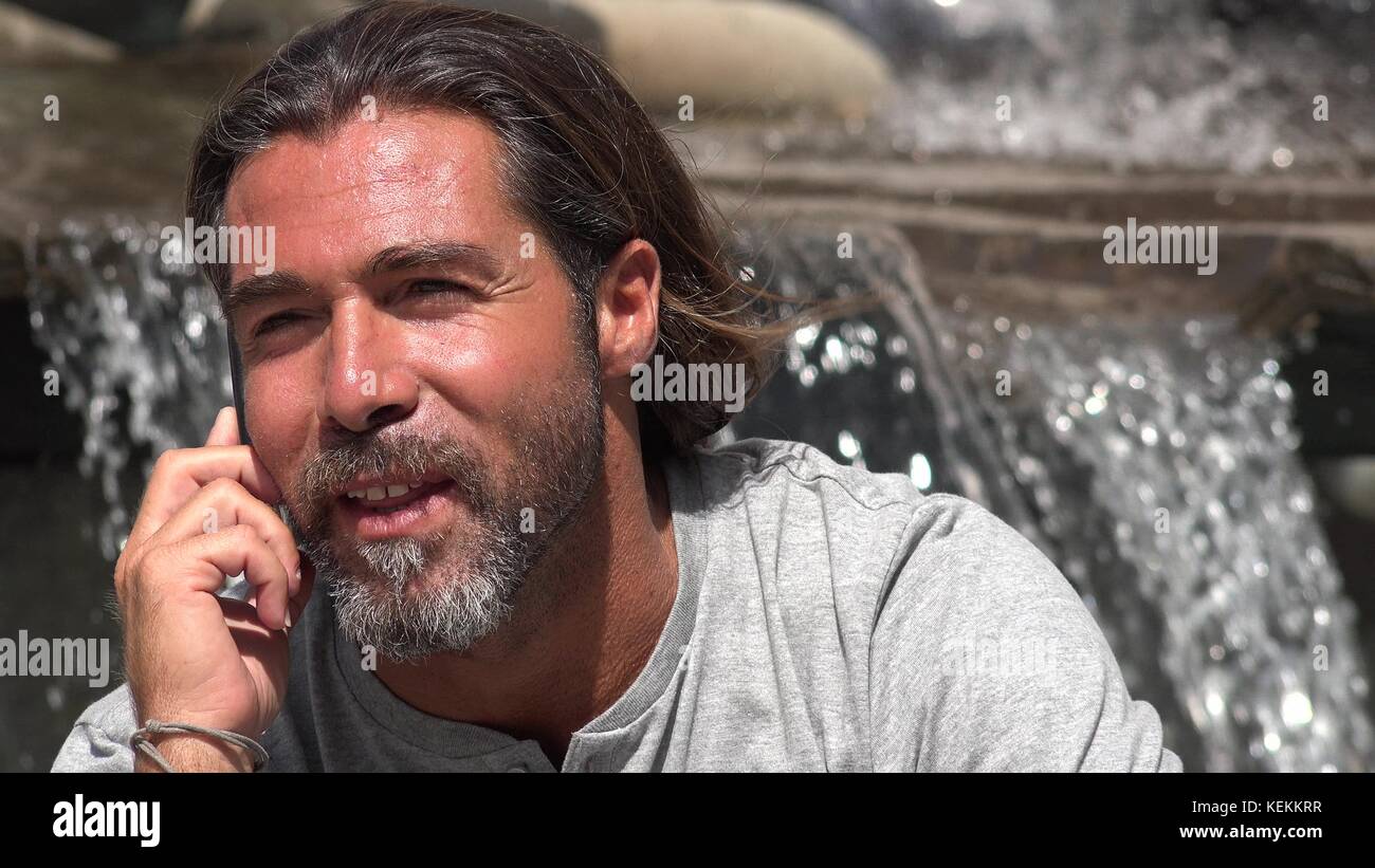 Handsome Spanish Male Talking On Phone Stock Photo