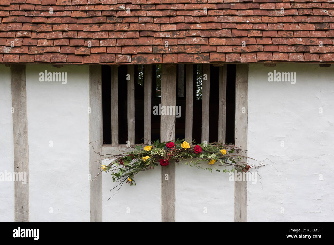 Autumn flower decoration on a medieval timber framed house window at Weald and Downland open air museum, autumn show, Singleton, Sussex, England Stock Photo