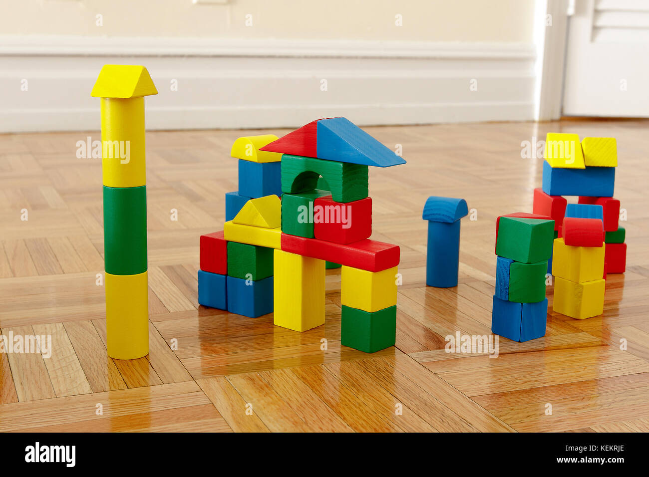 Colorful wooden building blocks on hardwood floor Stock Photo Alamy